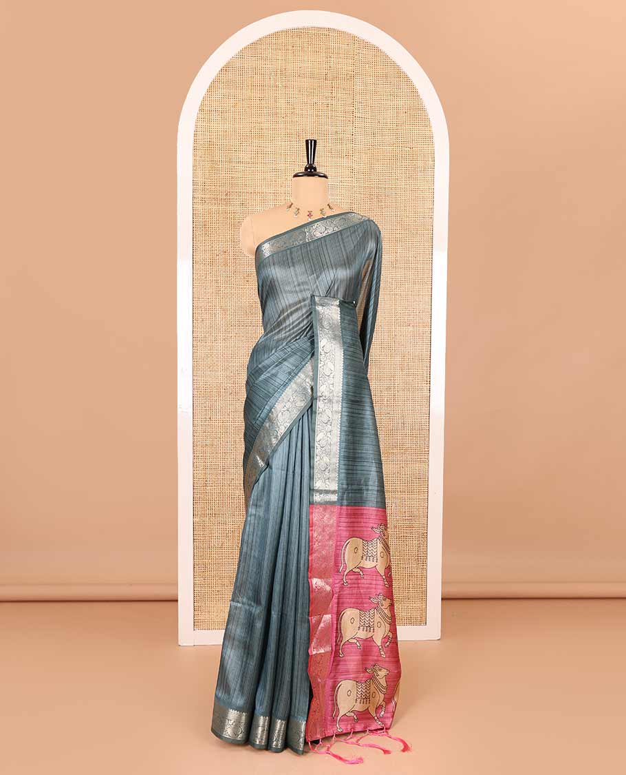 Blue striped semi-tussar saree, traditional zari border of floral creeper designs, contrast pallu of Pichwai cow print, and contrast Pichwai cow printed blouse