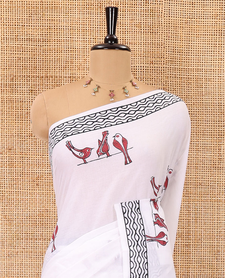 White sparrow motifs hand block printed soft mul cotton, block printed geometric border, intricate motifs printed pallu, and a contrast plain blouse