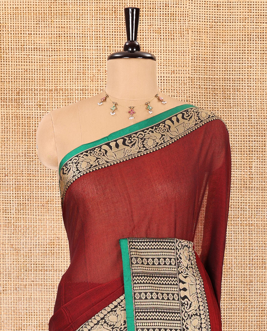 Maroon plain mercerised cotton saree, contrast traditional motifs thread woven border, striped pallu, and a matching blouse