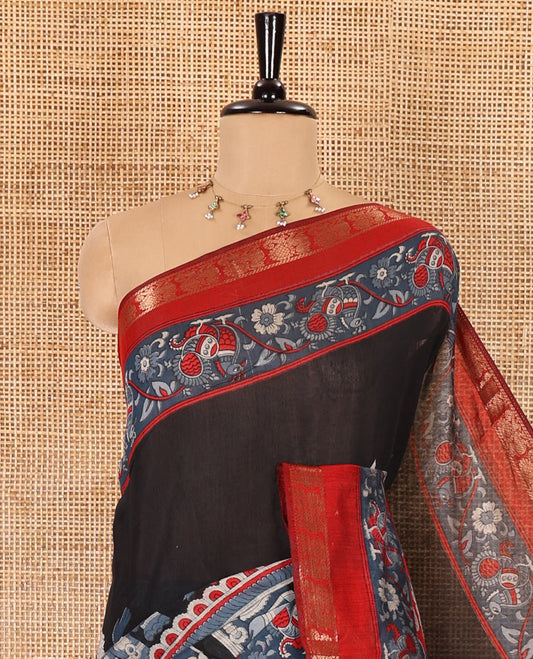 Black kalamkari ancient human figurines machine-printed muslin cotton saree, contrast traditional design zari border, kalamkari printed pallu, and contrast floral motifs and zari bordered blouse