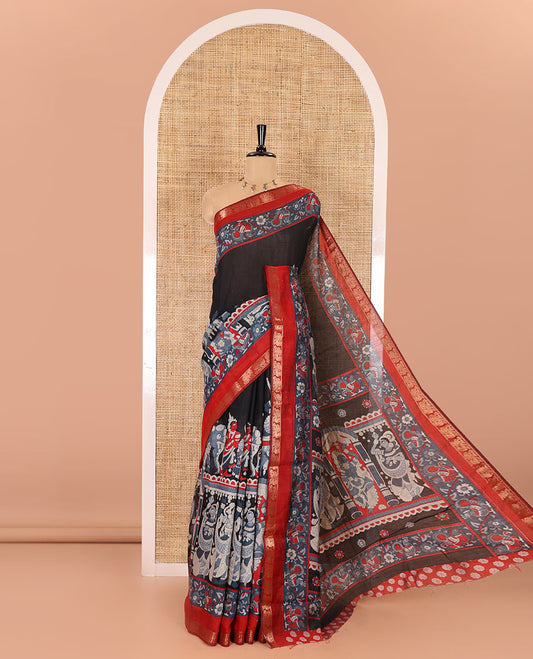Black kalamkari ancient human figurines machine-printed muslin cotton saree, contrast traditional design zari border, kalamkari printed pallu, and contrast floral motifs and zari bordered blouse