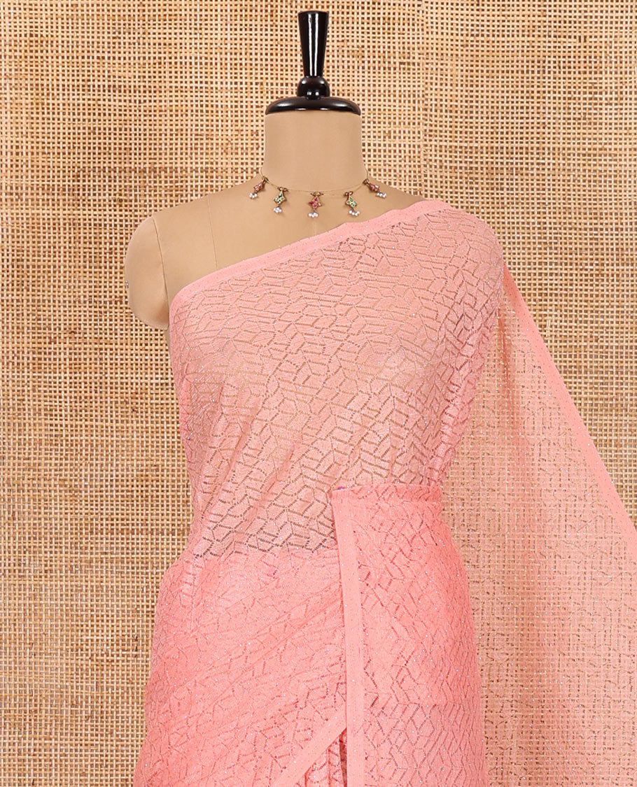 Borderless pink sparkling glittered russel net saree, self-pallu and a floral print with zig-zag embroidered blouse