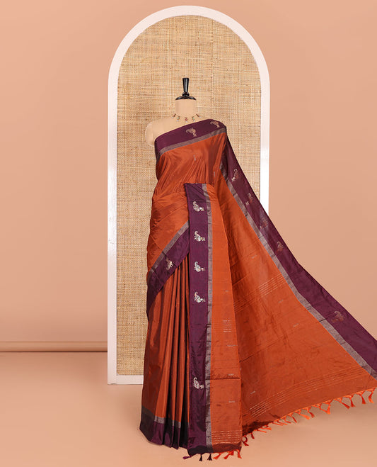 Rust orange dobby-style zari buttas semi-soft silk saree, contrast peacock zari border, zari design pallu, and a plain blouse