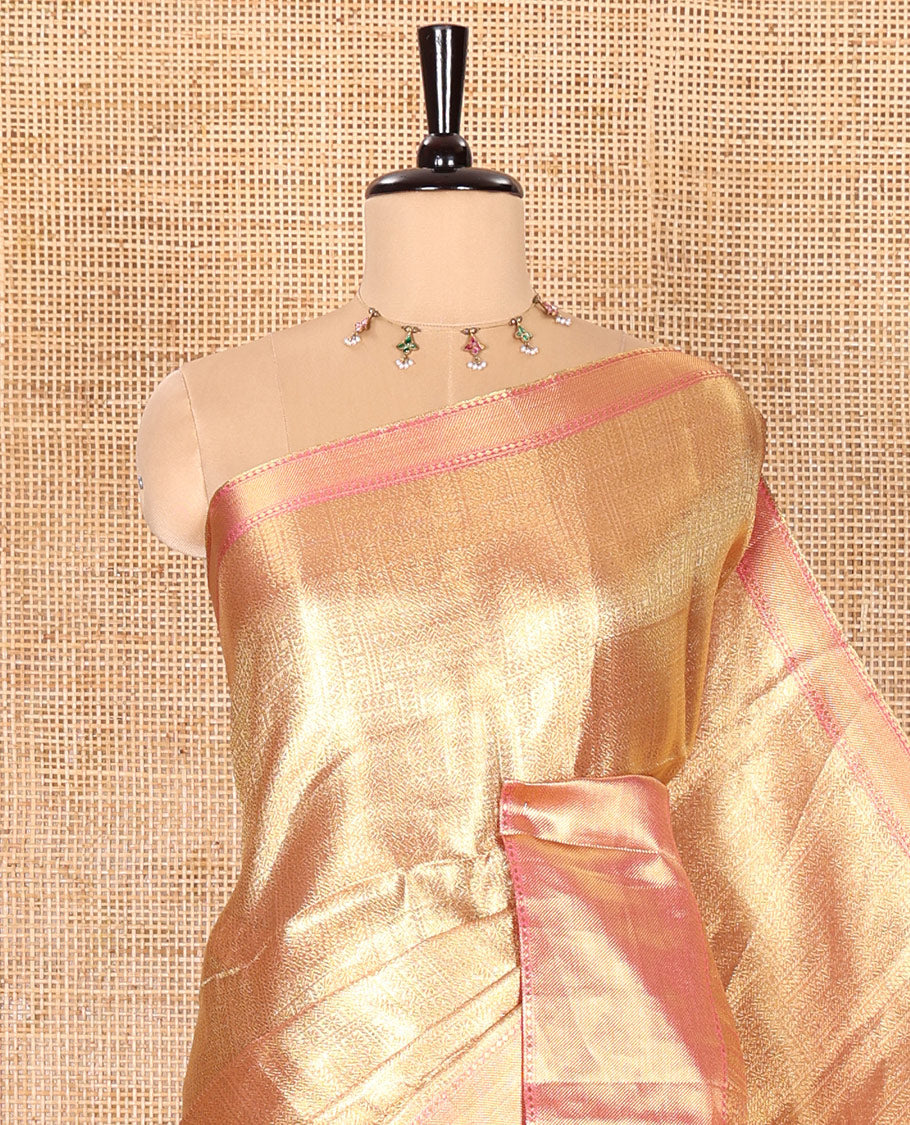 Gold Tissue Saree Features Floral Jacquard Design Woven All Over Its Body, Features a Contrast Gleaming Zari Traditional Design Border, Zari-Enriched Pallu, and a Matching Blouse