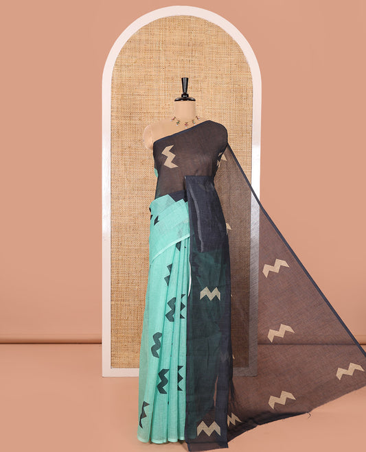 Borderless Green Linen Cotton Saree, Elegantly Printed with Zig-Zag Geometric Motifs, Pallu Mirrors the Same Motifs, and Paired with a Contrast-Printed Blouse