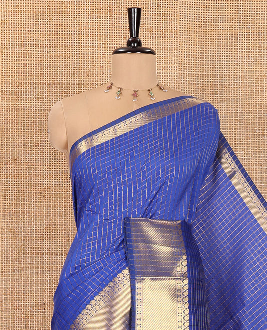 Royal Blue Semi-Katan Silk Saree, Elevated with Golden Zari Checks on Its Body, Highlighted by a Traditional Zari Border of Paisley and Rudraksham Designs, Gleaming Pallu, and Paired with a Matching Blouse