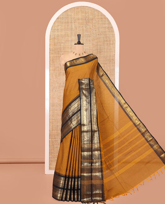 Mustard Plain Chettinad Cotton Saree, Complemented by a Contrast Rettai Pettu Dual-Color Zari Border of Temple, Coin, Elephant, and Peacock Designs, Subtly Striped Pallu, and Paired with a Matching Blouse