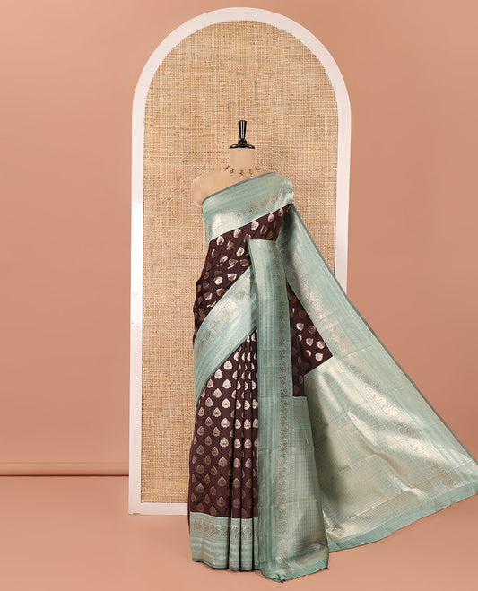 Brown and Green Kanchi Silk Saree, Meticulously Crafted with Zari Buttas All Over Its Body, Complemented by a Contrast Traditional Zari Border of Peacock Designs, an Intricately Designed Pallu, and Paired with a Contrast Blouse