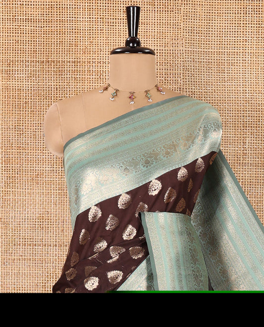 Brown and Green Kanchi Silk Saree, Meticulously Crafted with Zari Buttas All Over Its Body, Complemented by a Contrast Traditional Zari Border of Peacock Designs, an Intricately Designed Pallu, and Paired with a Contrast Blouse