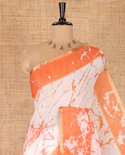 Cream and Orange Linen Cotton Saree, Adorned with Batik Print on Its Body, Complemented by Contrast Batik Printed Border, Pallu of Floral Print, and Paired with a Contrast Blouse