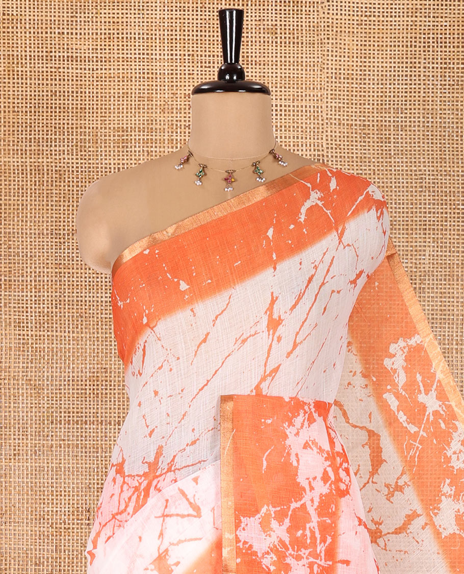 Cream and Orange Linen Cotton Saree, Adorned with Batik Print on Its Body, Complemented by Contrast Batik Printed Border, Pallu of Floral Print, and Paired with a Contrast Blouse