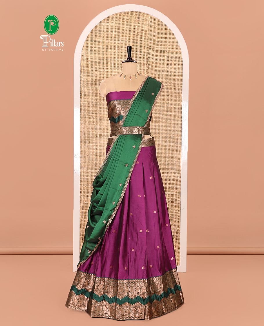 Purple and Green Semi-Banarasi Half-Saree Accentuated with Zari Buttas on Its Skirt, Complemented by Contrast Traditional Zari Border of Chakram Designs, Paired with a Matching Blouse, and a Satin Georgette Embroidered Scallop Dhavani