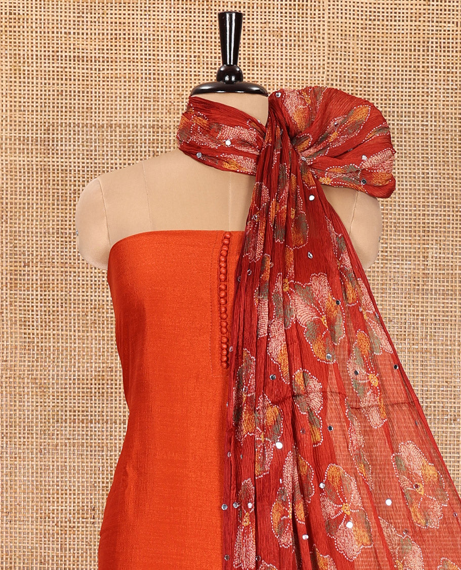 Orange Material Churidar Set, Bedecked up with Plain Vichitra Silk Top, Comes with a Plain Santoon Bottom, and Is Paired with a Crushed Chiffon Dupatta of Floral Print and Mirror Work
