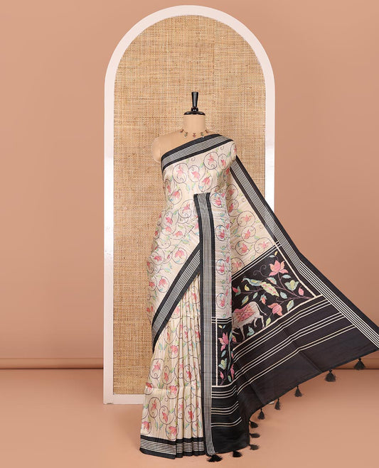 Chikku-black floral vine printed tissue patola saree, contrast striped border, pallu of floral and Pichwai cow motifs print, and a plain blouse