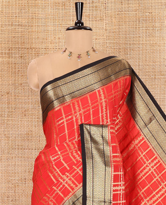 Red and Black Semi-Mysore Silk Saree Enriched with Intricate Zari Checks on Its Body, Complemented by a Contrast Geometric Patterns Zari Woven Border, Pallu Spotlighted with Chakram Motifs, and Paired with a Contrast Blouse