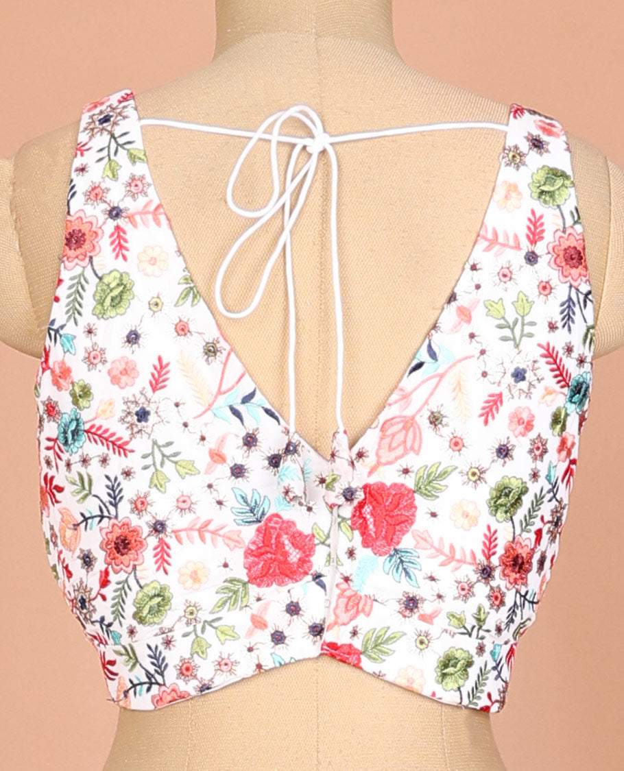 White floral motifs thread embroidered sleeveless readymade blouse with front and back deep-leaf neck
