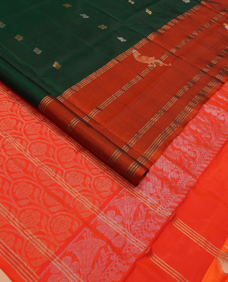 Green Uppada Silk Saree Enlivened With Zari Buttas, Captivating Contrast Border Featuring Zari Stripes And Peacock Motifs, Pallu Depicting Rose Flower-Enclosed Mughal-Style Arches, And Paired With A Contrast Blouse