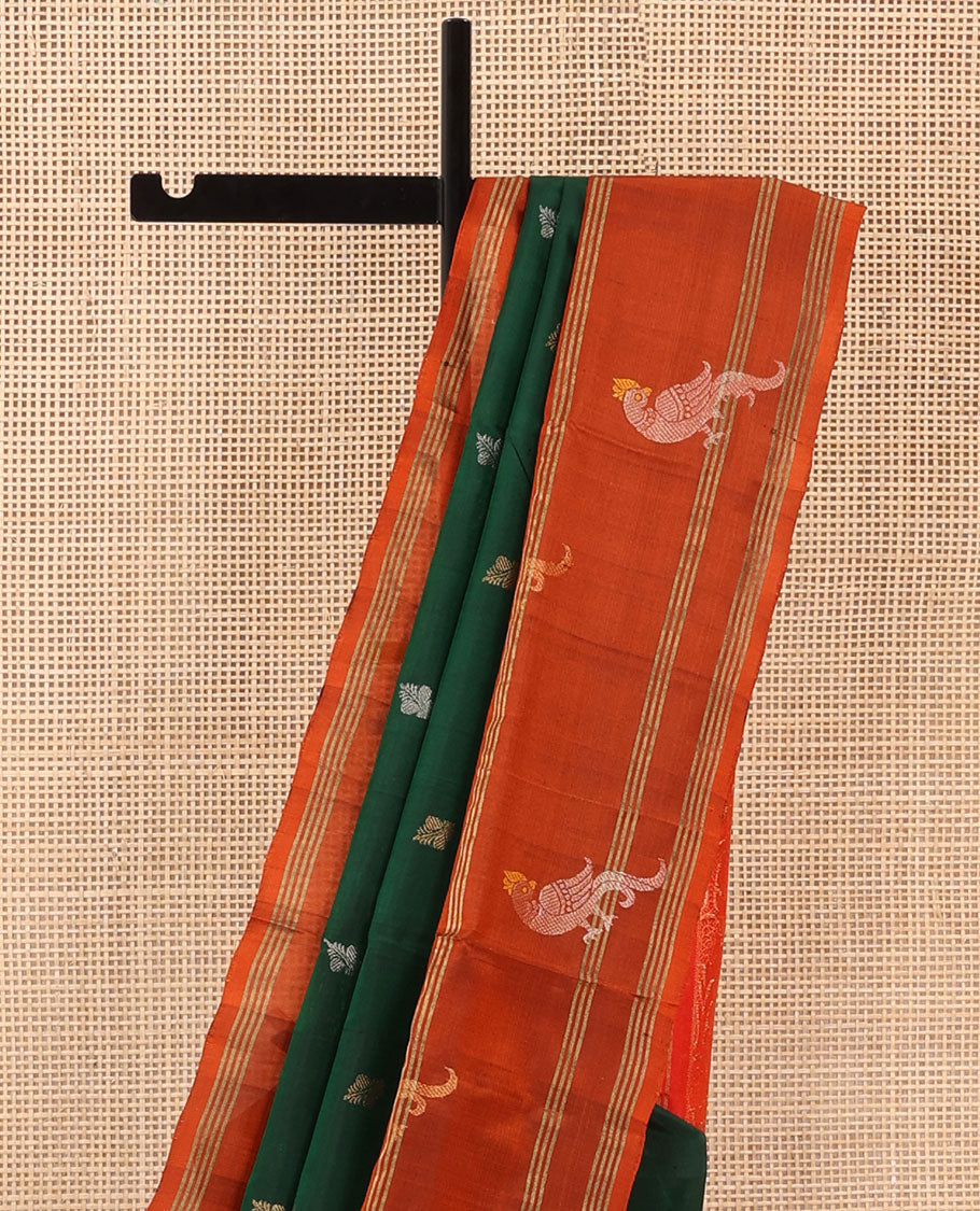 Green Uppada Silk Saree Enlivened With Zari Buttas, Captivating Contrast Border Featuring Zari Stripes And Peacock Motifs, Pallu Depicting Rose Flower-Enclosed Mughal-Style Arches, And Paired With A Contrast Blouse