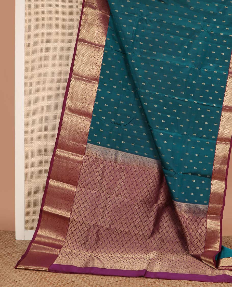 Blue zari buttas Vasundhara silk mix saree, contrast border of rekku, diamond, thilakam, and paiyaadi kattam, and intricate pallu