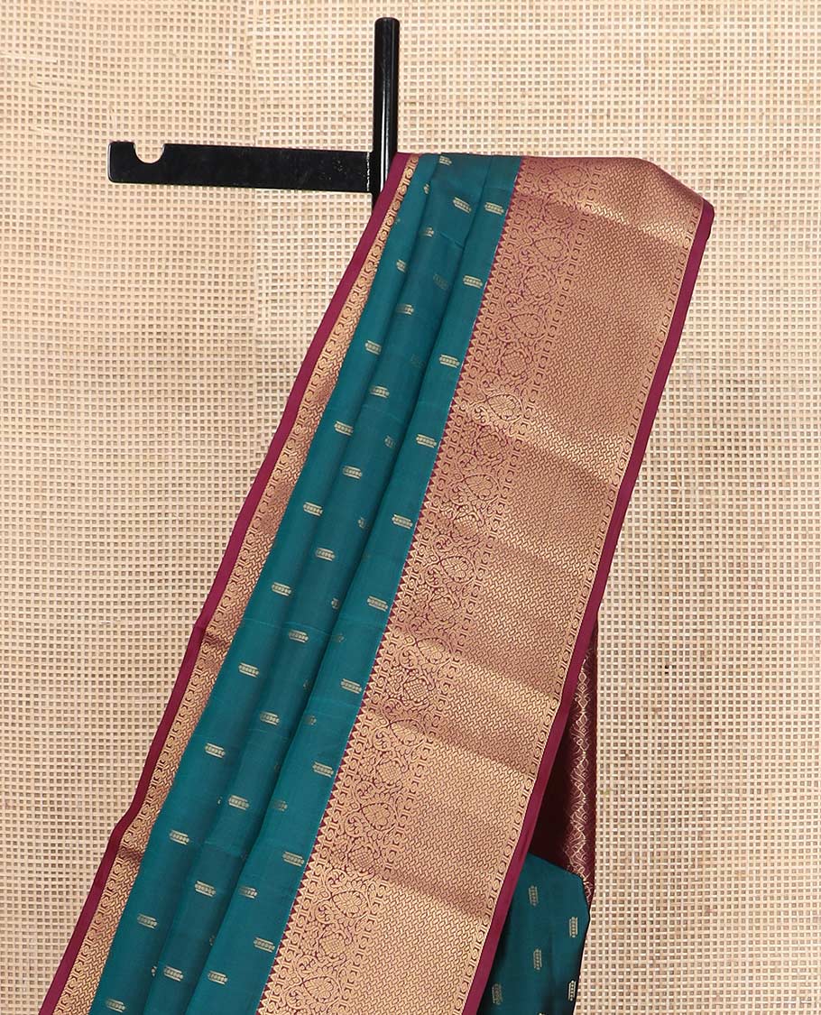 Blue zari buttas Vasundhara silk mix saree, contrast border of rekku, diamond, thilakam, and paiyaadi kattam, and intricate pallu