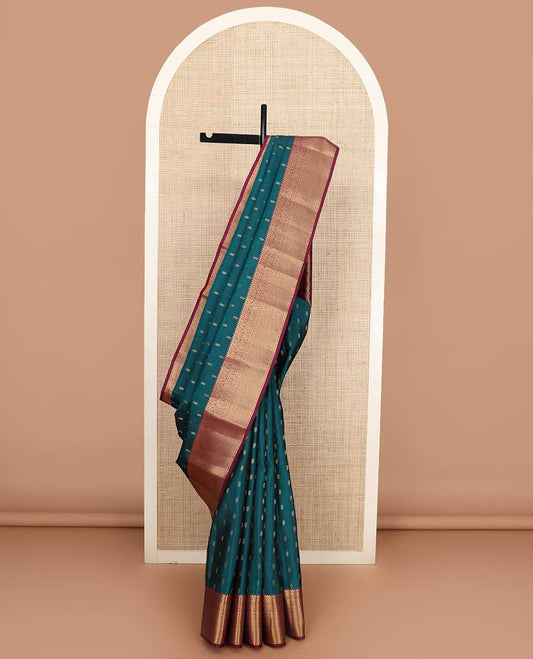 Blue zari buttas Vasundhara silk mix saree, contrast border of rekku, diamond, thilakam, and paiyaadi kattam, and intricate pallu