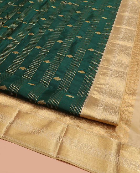 Green Vasundhara Lite Silk Mix Saree, Elegantly Highlighted with Zari Stripes and Manga Buttas All Over Its Body, Highlighted by Contrast Zari Border, Grandly Pallu Steeped with Thilakam Designs, and Paired with a Matching Blouse