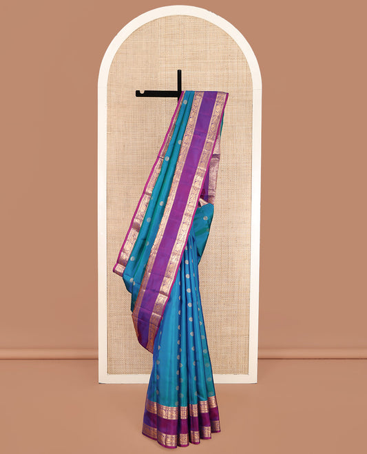 Blue Vasundhara Lite Silk Mix Saree, Majestically Detailed with Chakram Buttas on Its Body, Complemented by a Contrast Rettai Pettu Border of Salngai, Muthu, Mayil, and Yaali Designs, Intricately Designed Pallu, and Paired with a Contrast Blouse