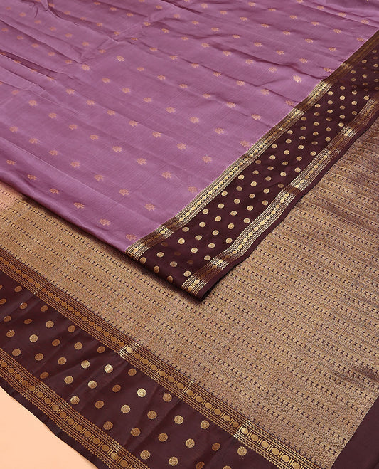 Purple Vasundhara Lite Silk Mix Saree, Adorned with Zari Buttas on Its Body, Complemented by a Contrast Border of Rekku, Muthu, Kathir, Rudraksham, and Chakram Designs, Pallu Steeped with Traditional Designs, and Paired with a Contrast Blouse