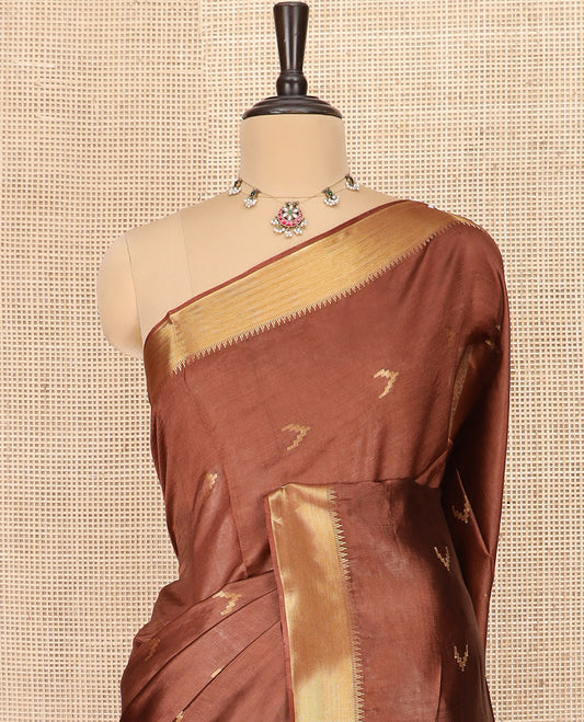 Brown Banana Pith Saree Decorated with Zari Temple Buttas, Delicately Woven Temple Zari Border, Gleaming Zari Pallu of Horizontal Stripes in Zari, and Paired with a Matching Plain Blouse