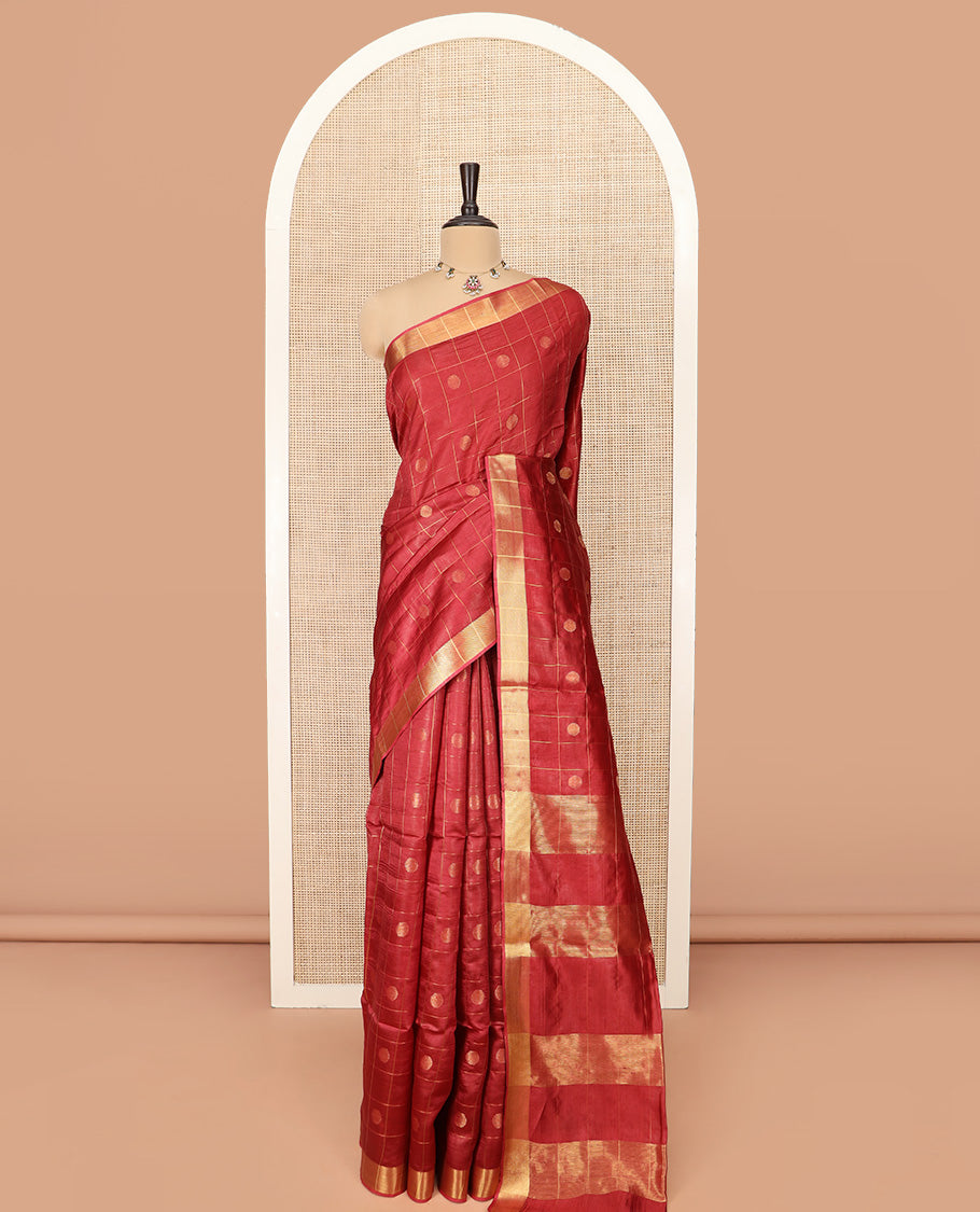 Red Banana Pith Saree Mesmerized with Polka Dot Buttas Enclosed Checks, Subtle Zari Border, Gleaming Zari Stripes Woven Pallu, and Paired with a Matching Plain Blouse