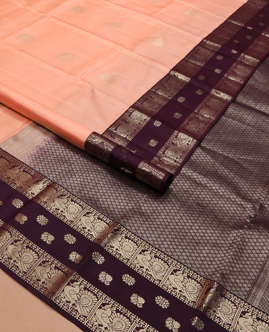Peach butta silk saree, contrast border of rekku, diamond, muthu, and mayil chakram designs, and jaal pallu