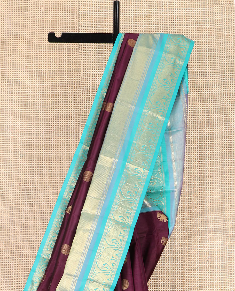 Purple Vasundhara Silk Saree Beautified with Yaanai and Poun Buttas, Complemented by a Contrast Border of Neli, Mayil Kann, Muthu, Banaras, and Yaanai Designs, Pallu Woven in Jaal Design, and Paired with a Contrast Blouse
