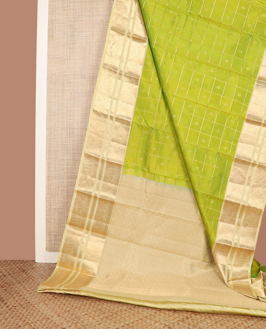 Green zari buttas silk saree, contrast border of kuyil kann, banaras, and mayil designs, and ogee patterned pallu