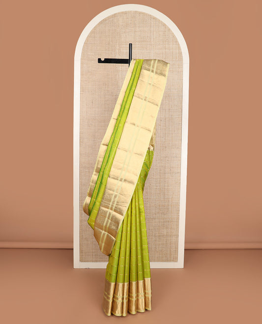 Green zari buttas silk saree, contrast border of kuyil kann, banaras, and mayil designs, and ogee patterned pallu