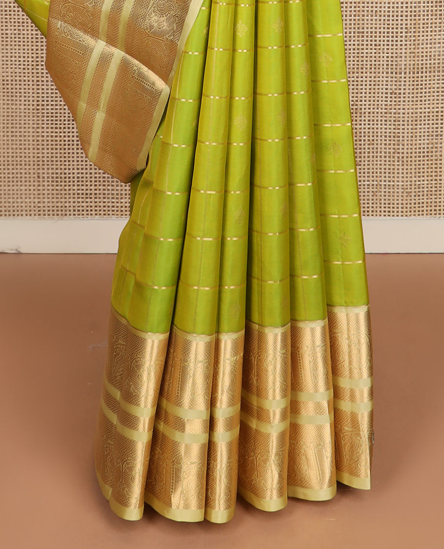 Green zari buttas silk saree, contrast border of kuyil kann, banaras, and mayil designs, and ogee patterned pallu