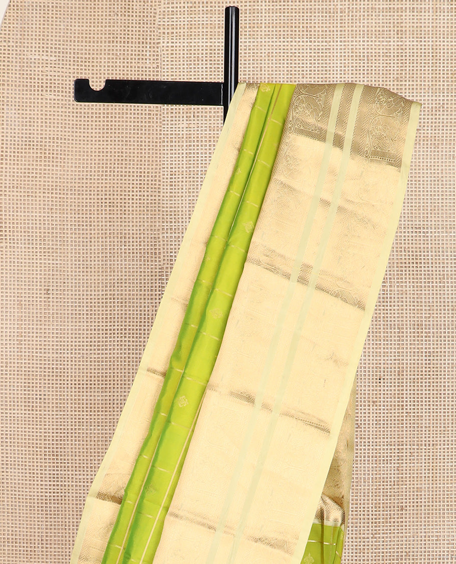 Green zari buttas silk saree, contrast border of kuyil kann, banaras, and mayil designs, and ogee patterned pallu