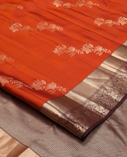 Orange floral buttas Vasundhara silk saree, contrast border of rekku, mayil kann, and mayil designs, and chevron striped pallu