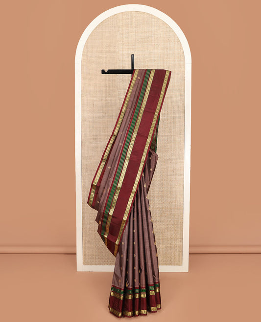 Brown Vasundhara Silk Saree Richly Detailed with Zari Buttas, Complemented by a Contrast Varisai Pettu Border of Muthu, Rekku, and Rudraksham Designs, Intricately Designed Pallu, and a Contrast Blouse