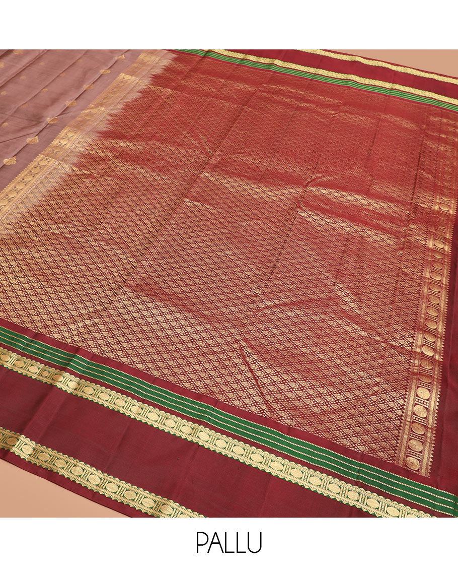 Brown Vasundhara Silk Saree Richly Detailed with Zari Buttas, Complemented by a Contrast Varisai Pettu Border of Muthu, Rekku, and Rudraksham Designs, Intricately Designed Pallu, and a Contrast Blouse