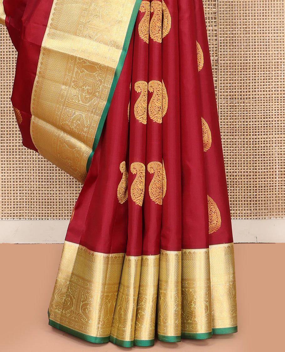 Maroon Vasundhara Silk Saree, Adorned with Arumbu Manga Buttas All Over Its Body, Complemented by Contrast Border of Thilakam Mokku, Mayil and Mayil Kann Designs, Grand Pallu and Paired with a Contrast Blouse