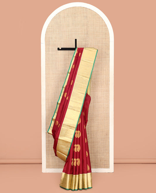 Maroon Vasundhara Silk Saree, Adorned with Arumbu Manga Buttas All Over Its Body, Complemented by Contrast Border of Thilakam Mokku, Mayil and Mayil Kann Designs, Grand Pallu and Paired with a Contrast Blouse