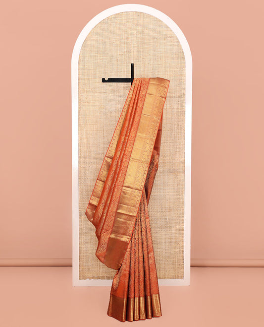 Orange Kanchipuram Wedding Silk Saree, Artfully Detailed with Jacquard Design on Its Body, Highlighted by Zari Border of Thilakam, Kuyil Kann, Diamond, Mayil, Yaali, and Yaanai Designs, Grand Jaal Pallu, and Paired with a Matching Blouse