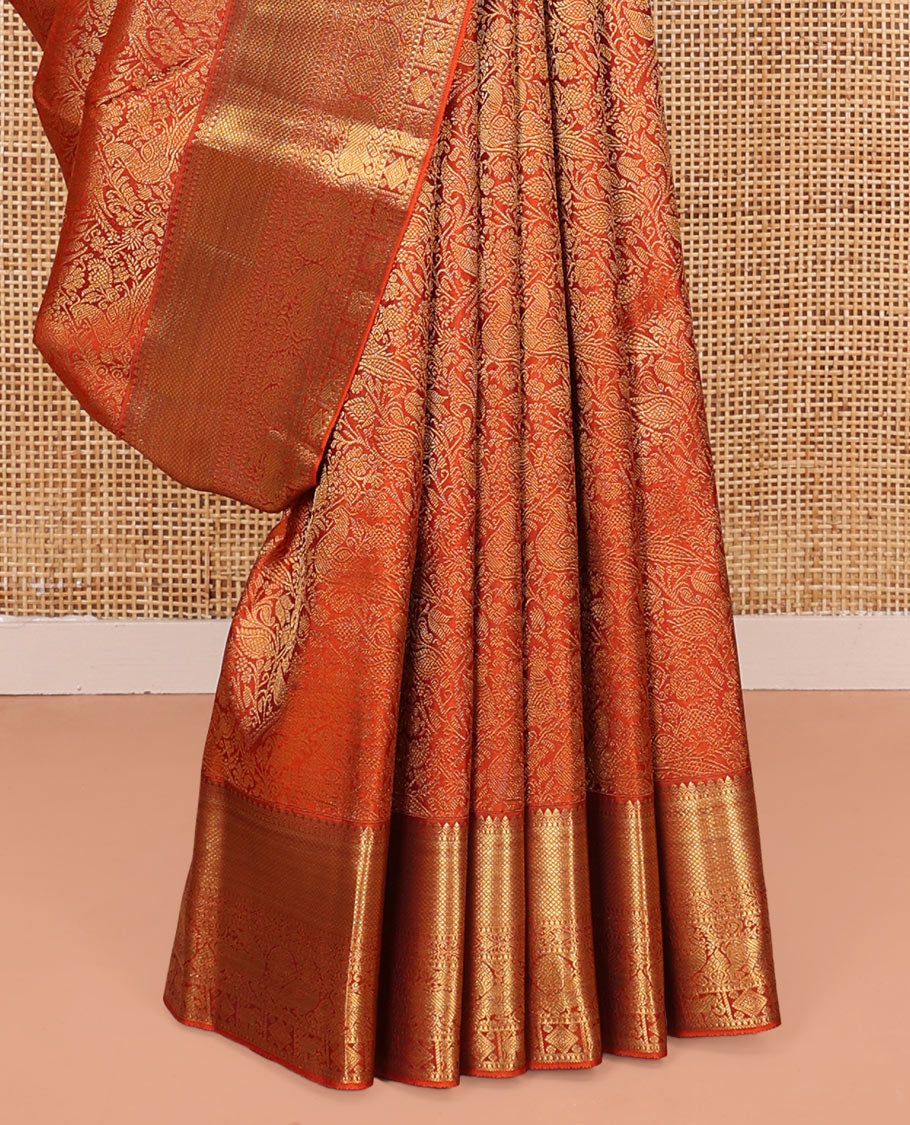 Orange Kanchipuram Wedding Silk Saree, Artfully Detailed with Jacquard Design on Its Body, Highlighted by Zari Border of Thilakam, Kuyil Kann, Diamond, Mayil, Yaali, and Yaanai Designs, Grand Jaal Pallu, and Paired with a Matching Blouse