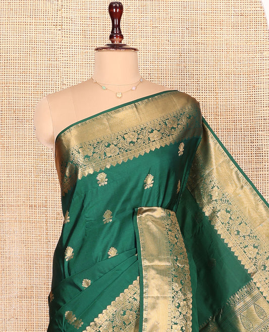 Green Budget Silk Saree Enlivened with Zari Buttas All Over Its Body, Highlighted by a Zari Traditional Border of Floral Creeper Designs, Grand Pallu of Scallop Designs, and Paired with a Matching Blouse