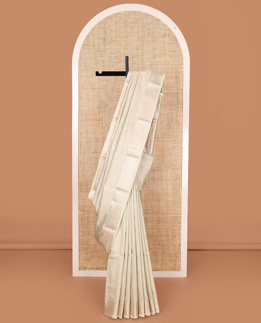 Cream buttas kathan silk saree, traditional zari border, and intricately designed pallu