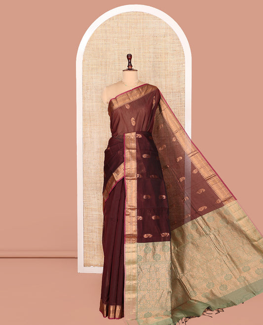 Brown Semi-Silk Cotton Saree, Ornamented with Paisley Zari Buttas on Its Body, Highlighted by a Traditional Zari Design Border, Captivating Contrast Pallu of Floral Designs, and Paired with a Contrast Blouse