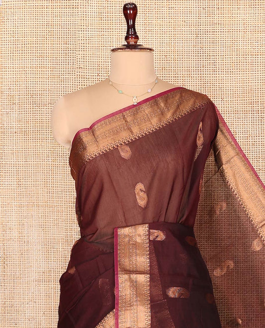 Brown Semi-Silk Cotton Saree, Ornamented with Paisley Zari Buttas on Its Body, Highlighted by a Traditional Zari Design Border, Captivating Contrast Pallu of Floral Designs, and Paired with a Contrast Blouse