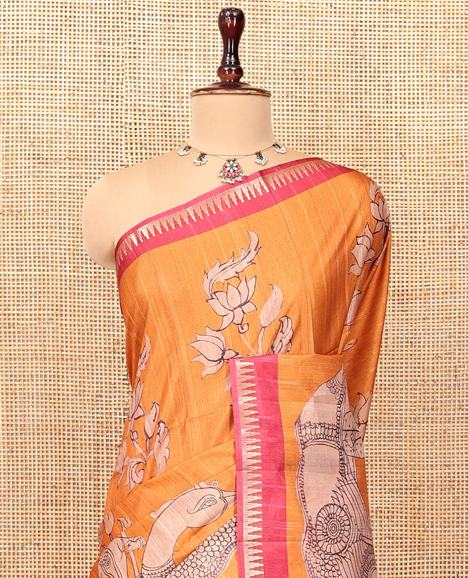 Orange Semi-Tussar Silk Saree, Artfully Detailed with Kalamkari-Style Human Motifs Printed on Its Body, Complemented by a Contrast Temple Zari Border, Creatively Kalamkari Printed Pallu, and Paired with a Contrast Blouse