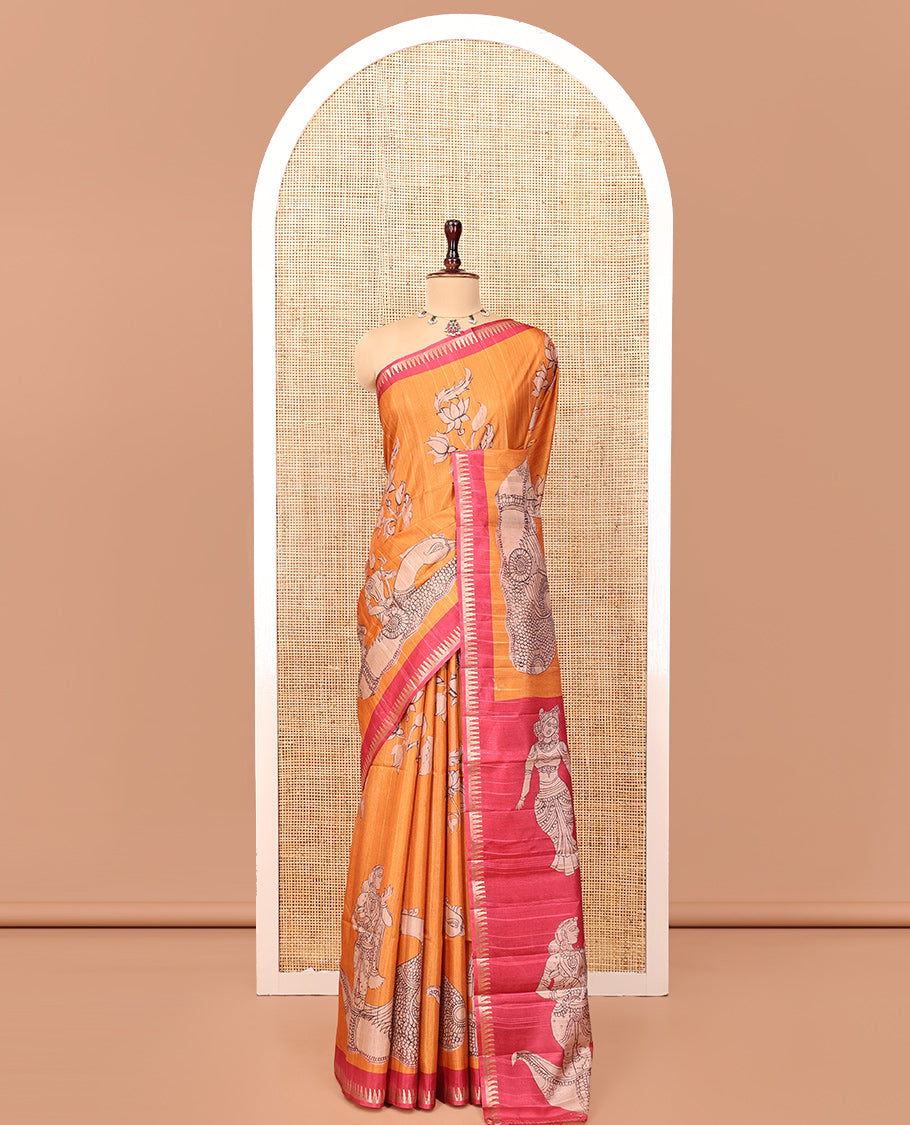 Orange Semi-Tussar Silk Saree, Artfully Detailed with Kalamkari-Style Human Motifs Printed on Its Body, Complemented by a Contrast Temple Zari Border, Creatively Kalamkari Printed Pallu, and Paired with a Contrast Blouse