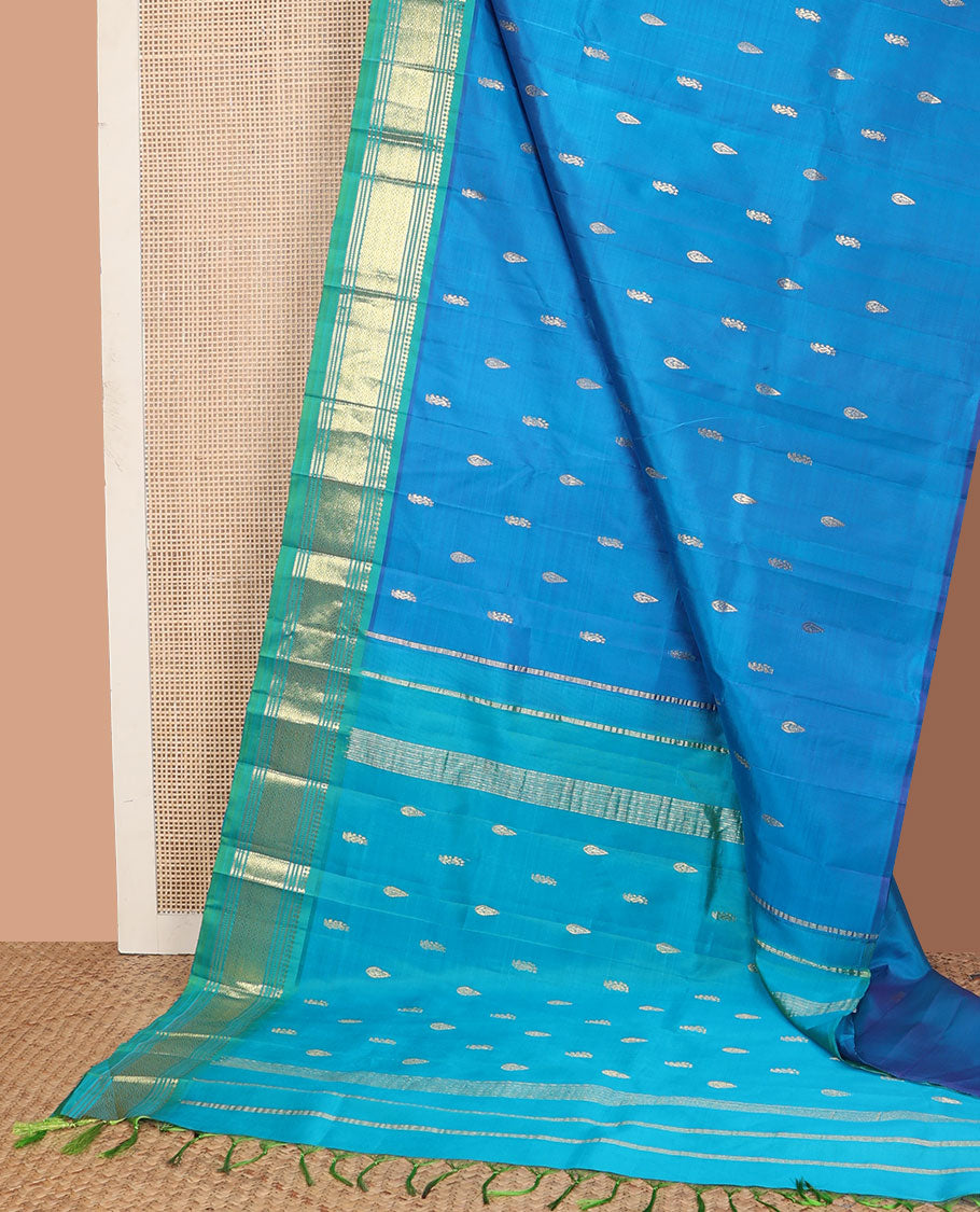 Blue zari buttas Kanchipuram silk saree, contrast one-sided border of paneer sombu, banaras, muthu, and jaal designs, and zari design pallu